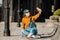 Girl sitting on skateboard and use mobile phone. Outdoors, urban lifestyle. cute skater girl sitting on skate board checking smart