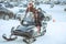 Girl sitting on a snowmobile