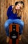 The girl sitting on the speaker