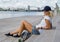 Girl sitting on stairs with longboard