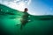 Girl sitting on surf board