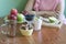 Girl sitting at the table. apples on a wooden Board in the kitchen. Food preparation