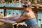 Girl sitting at a table on the poolside terrace