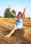 Girl sitting up on straw roll