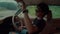 A girl is sitting in a vintage red car getting ready to hit the road