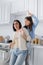 girl sitting on worktop in kitchen