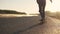 Girl skates on a skateboard on a deserted highway at sunset. Youth subculture. back view. slow motion