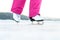 Girl skating on outdoor ice. Skater on frozen lake or pond.