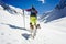 Girl ski touring in the mountains only with her dog on a sunny day