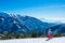 Girl Skier Admiring the Panorama of Snow-Capped Mountains