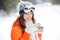 Girl in skier in bright clothes and coffee