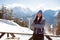 Girl-skier on the hill posing in interior of verandah of cafe at a ski resort