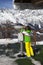 Girl skier looks through binoculars on observation deck of ski resor