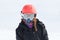 Girl skier portrait wrapped up warm in skiing gear with orange h