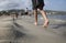 Girl with skirt walking barefoot in magaluf beach