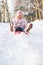 Girl Sledging Through Snowy Woodland