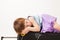 Girl sleeping on a road suitcase on white background