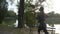 Girl with slender figure jogging on an alley park near the lake trying to relax and stay motivated in slow motion -