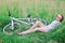 Girl with a slender figure lying on fresh green grass