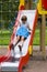 Girl sliding on playground