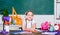 Girl small child eating apple fruit. Snack between lessons. Schoolgirl sit desk chalkboard background. Kid student in