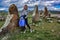 The girl with a small child near a megalithic standing stone, Zorats karer or Karahunj is a prehistoric monument in