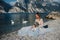 A girl in a smart white dress is sitting on the embankment of lake Garda.A woman is photographed against the background of a