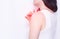 Girl smears a sore shoulder joint with anti-inflammatory ointment to relieve pain and inflammation, copy space, rheumatism