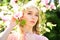 Girl smell pink magnolia flowers sunny spring. girl with beautiful magnolia flower