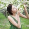 Girl smelling apple flowers