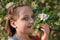 Girl smelling the blossoms of an apple tree