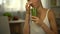 Girl smells green smoothie, feels disgust, tasteless but healthy diet, closeup