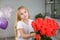 A girl with a smile gives a bouquet of flowers for Mother\\\'s Day