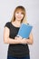 Girl is with a smile and holds folder with documents to his chest