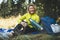 Girl smiles drink coffee thermos on nature after training, woman hold mug of warm tea outdoors, hiker laughing enjoys breakfast