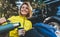 Girl smiles and enjoys outdoors summer nature, tourist hold hand mug of warm tea during recreation trip, happy hiker drink coffee