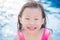 Girl smiles at swimming pool