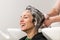 Girl smiling during her hair being washed