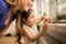 Girl smiling while knocking and peeking into the terrarium with her mother