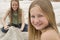 Girl Smiling With Sister Making Sand Castle In Background