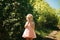 A girl sniffs lilac bushes. blooming gardens