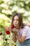 Girl sniffs a red flower.teenager girl smelling roses