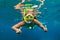 Girl in snorkeling mask dive underwater with coral reef fishes