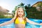 Girl with snorkling mask posing in swimming pool