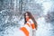 Girl in snow. Winter portrait of young woman in the winter snowy scenery. Portrait of a young woman in snow trying to