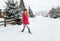 Girl snowdrift outside village or country, winter cold snow weather, woman in red jacket or clothes outdoor countryside