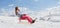 Girl on a snowy mountain riding a sleigh