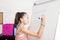 Girl Solving Math`s Sums On Flip Chart At Home