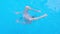 Girl somersaults and plays in the transparent blue swimming pool water. Child have fun in swim pool. Full HD slow motion