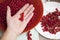 The girl sorts and sorts red currants in the kitchen,